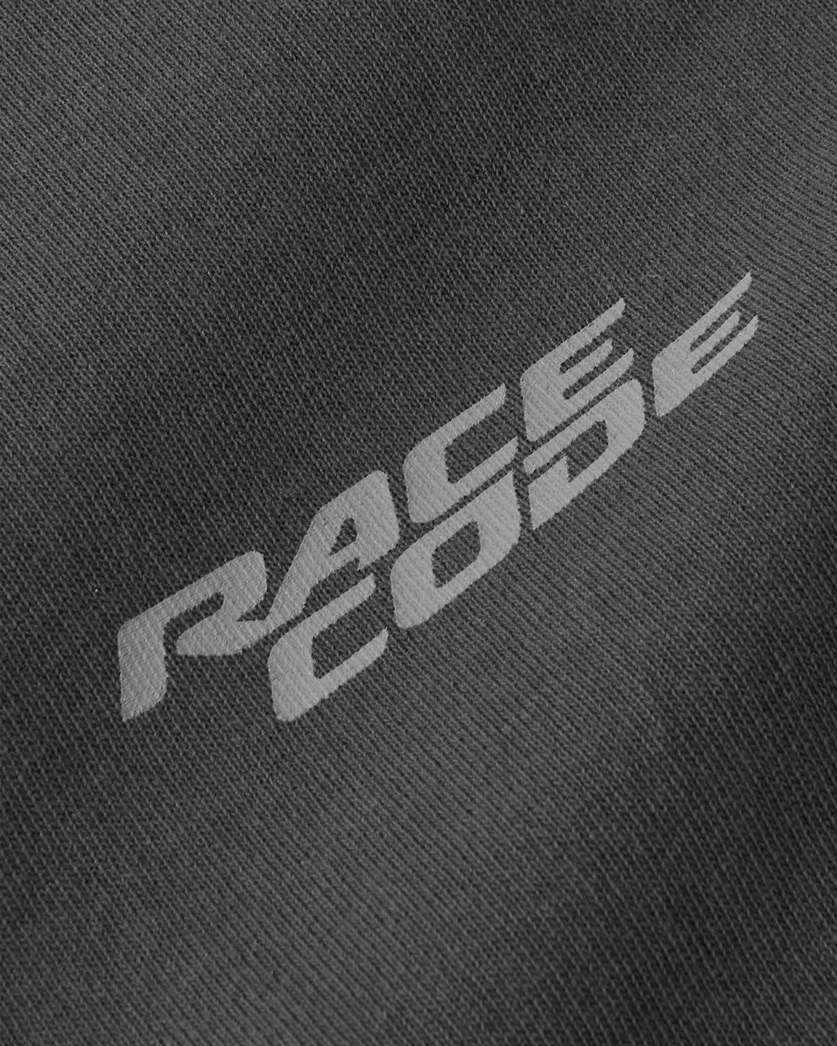 Close-up of grey Race Code chest logo on Race Tee Dark Grey