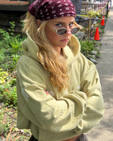 Woman wearing the Circuit Club Khaki Hoodie outdoors