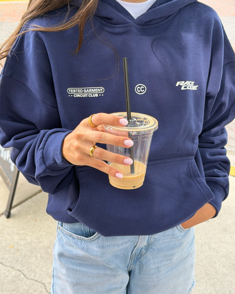 Woman wearing the Circuit Club Navy Hoodie outdoors