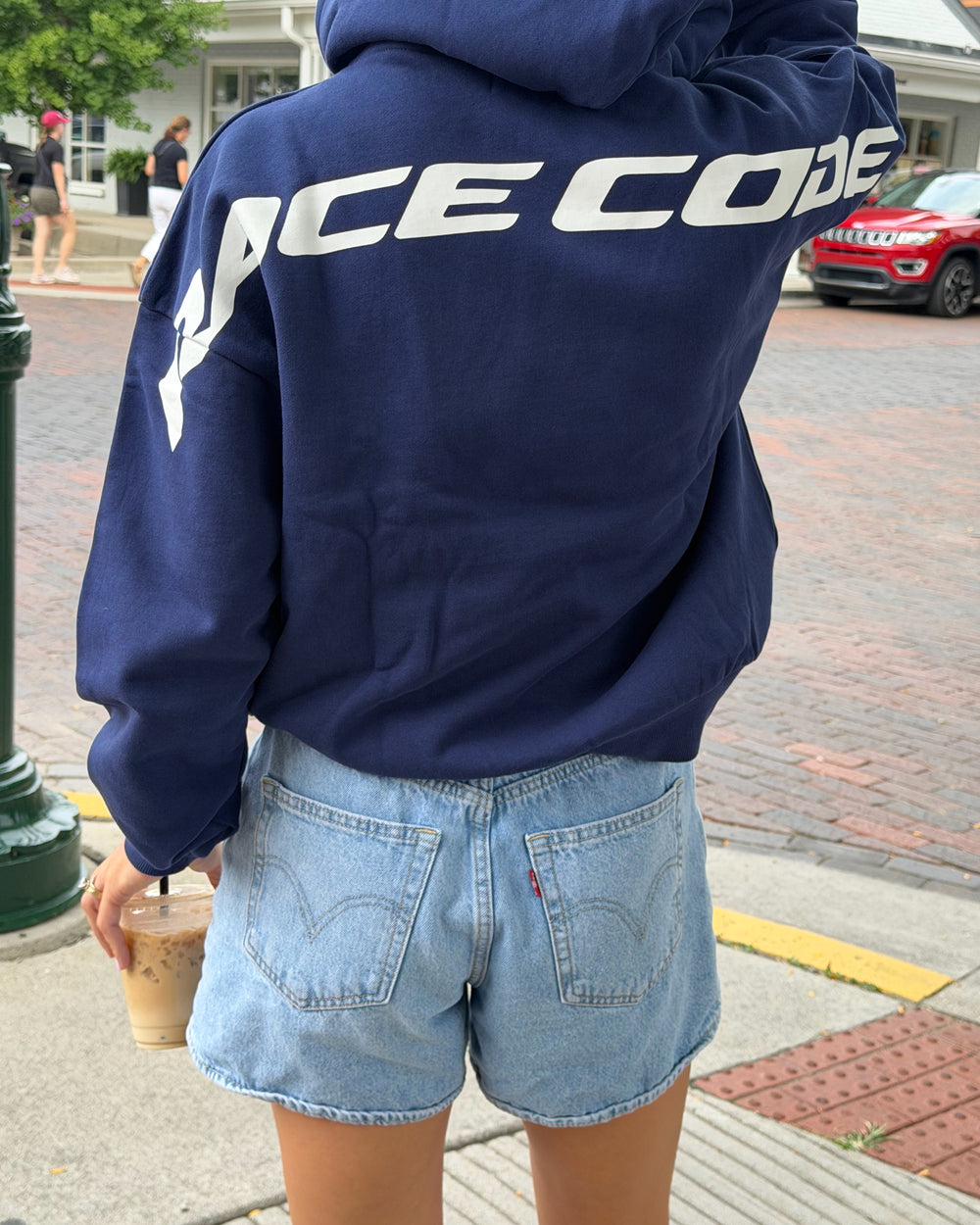 Woman wearing the Circuit Club Navy Hoodie, back detail