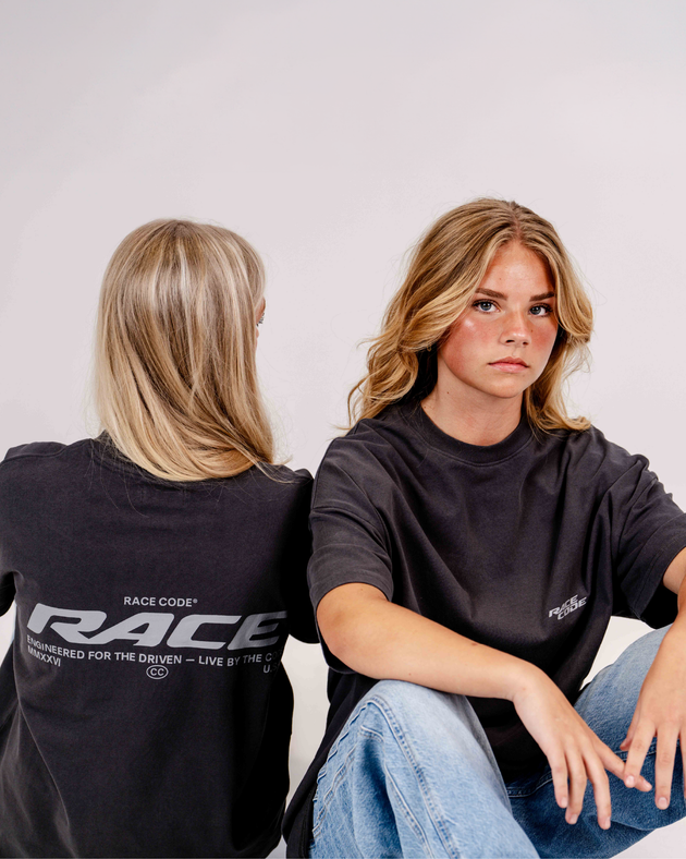 Two models in Race Code RACE tees — Engineered for the Driven graphic, motorsport streetwear