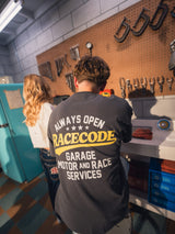 Garage Tee Dark Grey worn from the back in the garage, Always Open print