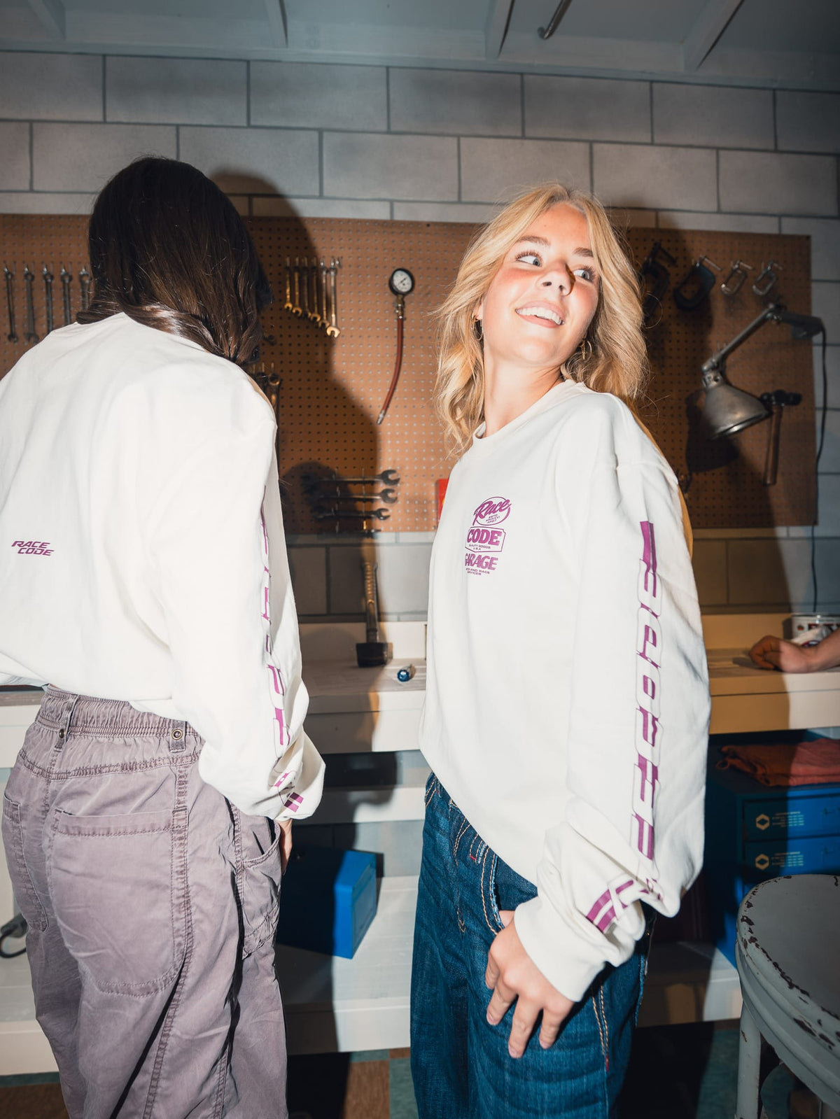 Flame Long Sleeves worn in the garage, showing the chest badge and sleeve graphics