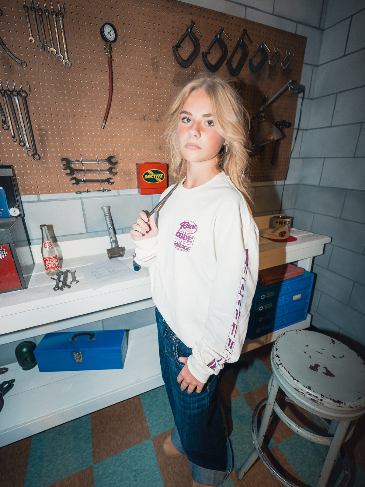 Model in the Flame Long Sleeves in front of a garage tool wall